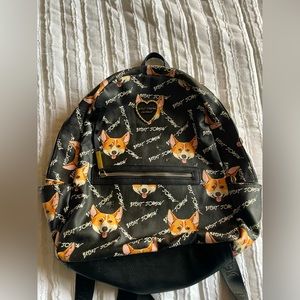 Betsey Johnson black book bag with corgi print on infused and out.
